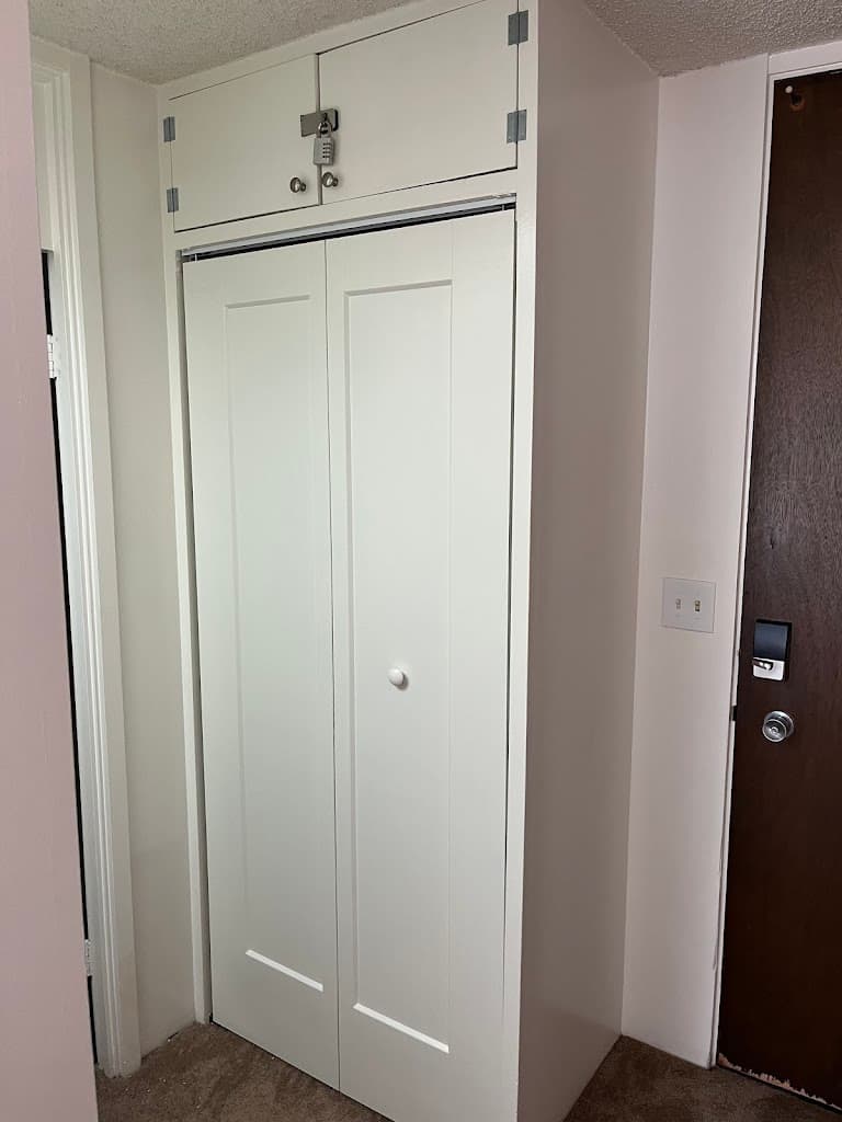 Finished bifold closet doors and built-in storage cabinet